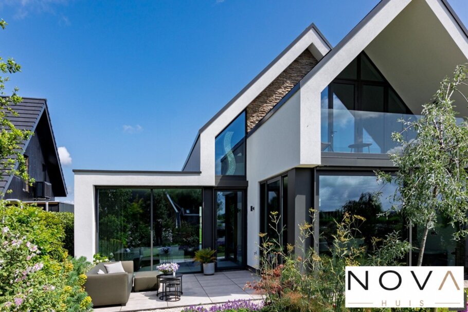 Moderne woning met hoge glazen achtergevel en schuifpuien
